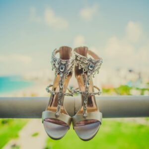 Stylish high heels with jewels, set against a beautiful scenic view, embodying elegance and luxury.