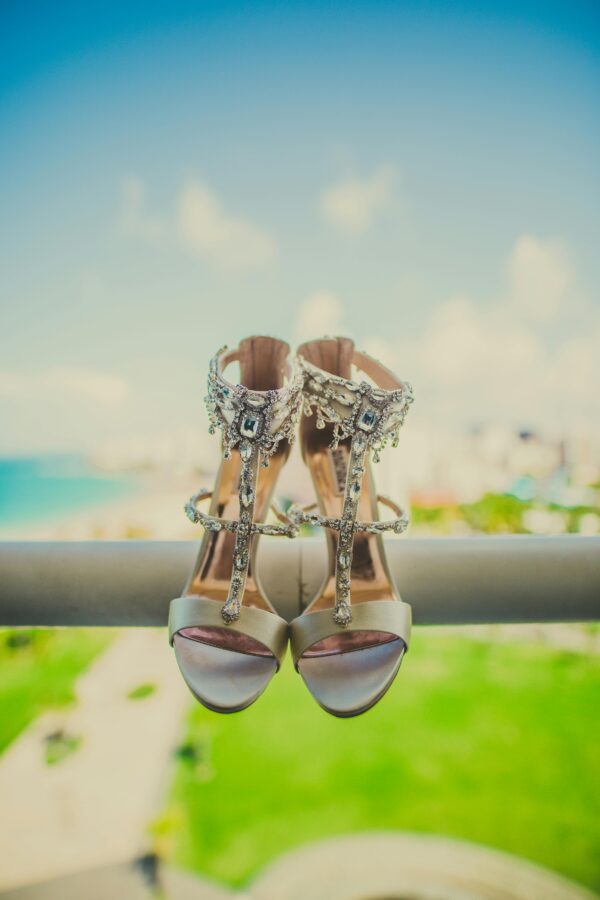 Stylish high heels with jewels, set against a beautiful scenic view, embodying elegance and luxury.