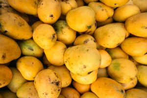 A close-up of ripe Indian mangoes in vibrant yellow hues, perfect for summer fruit themes.